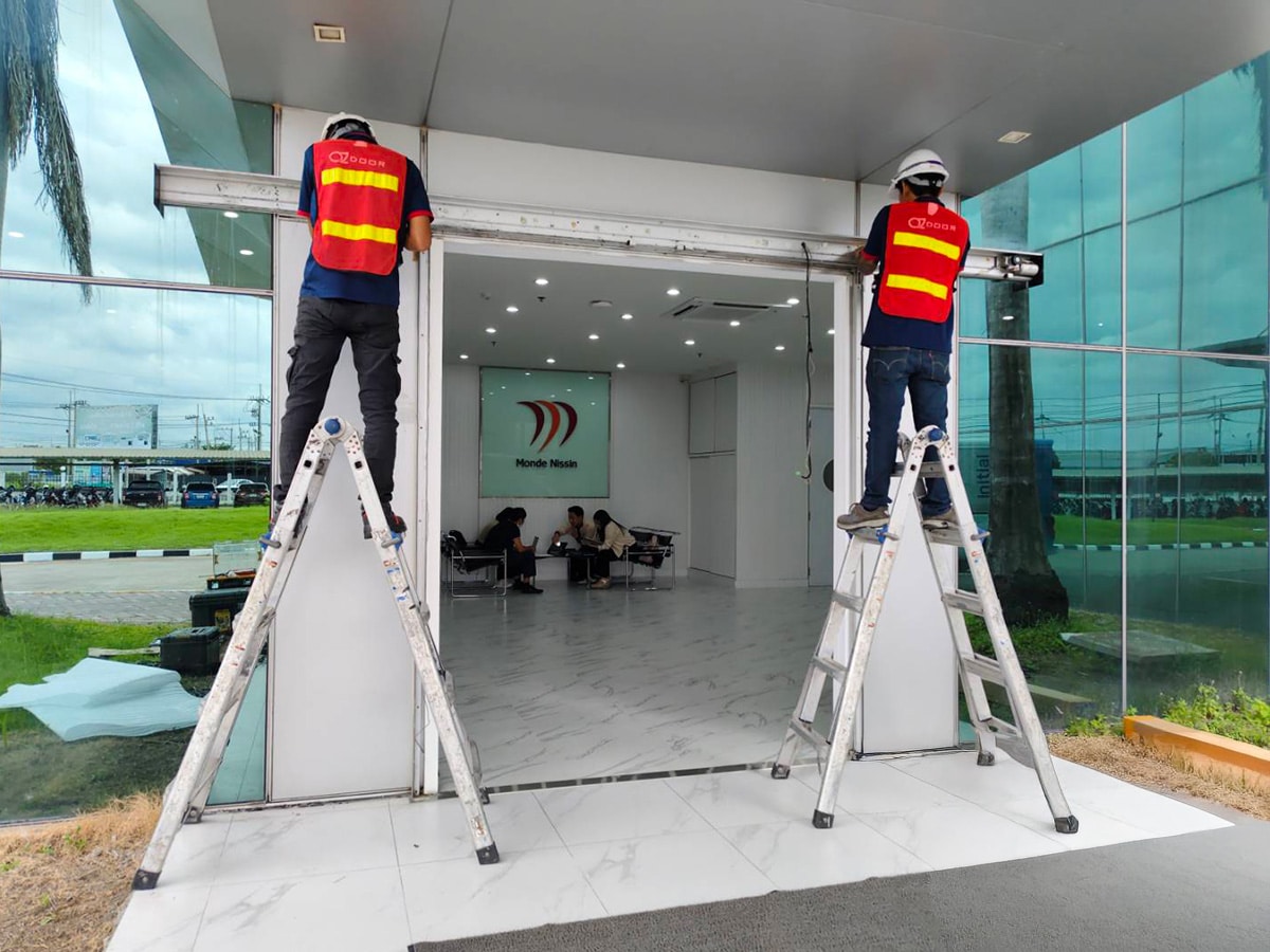 High speed door installation by certified OZ Door technicians at a commercial building entrance