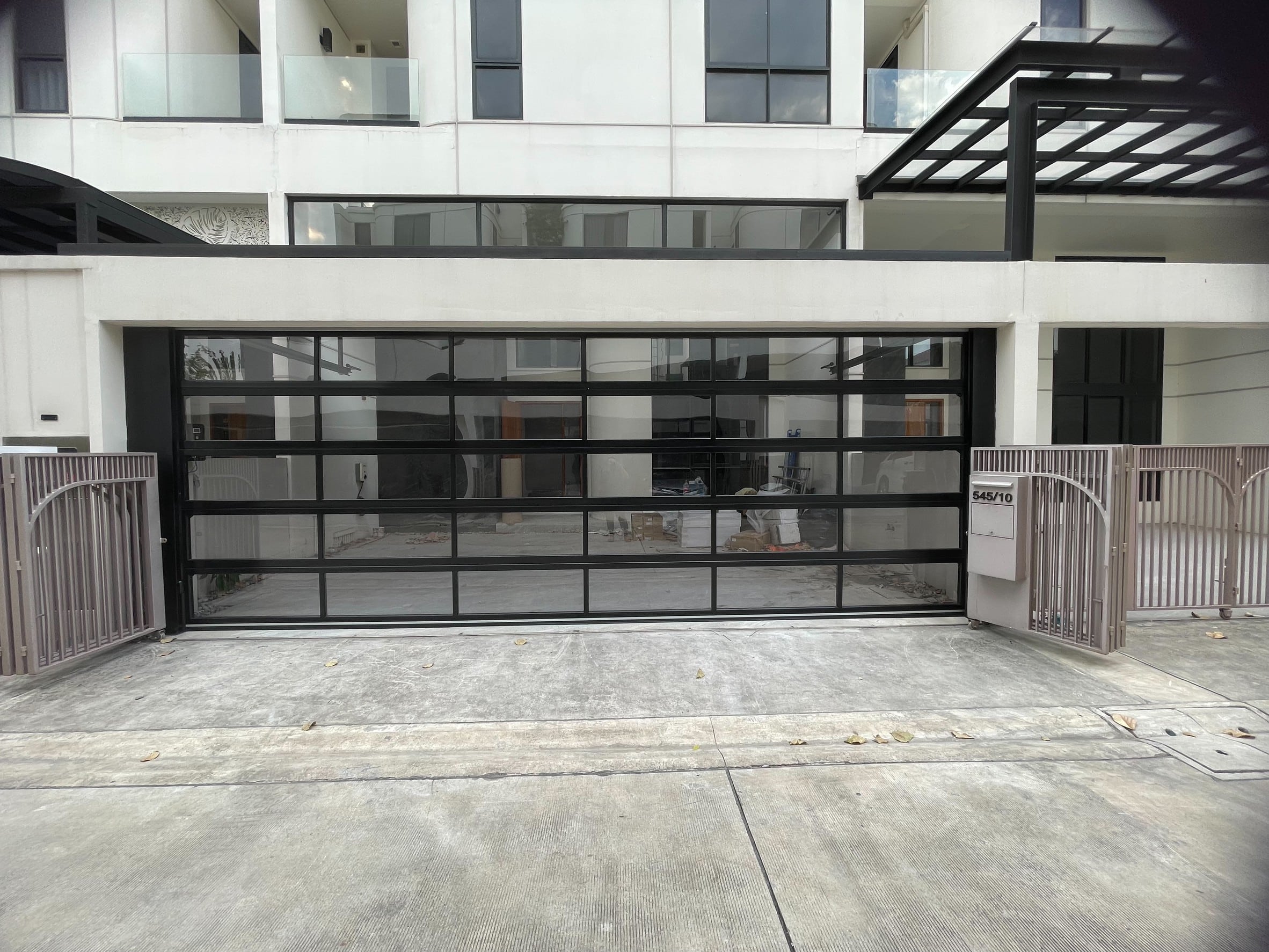 Installation photo of Full View Garage Door for Residential Projects in Bangkok by OZ DOOR