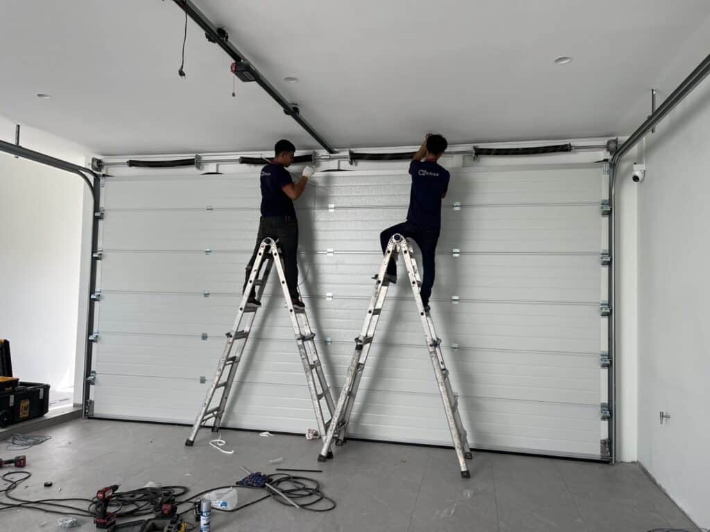 Professional garage and industrial door installation team on site