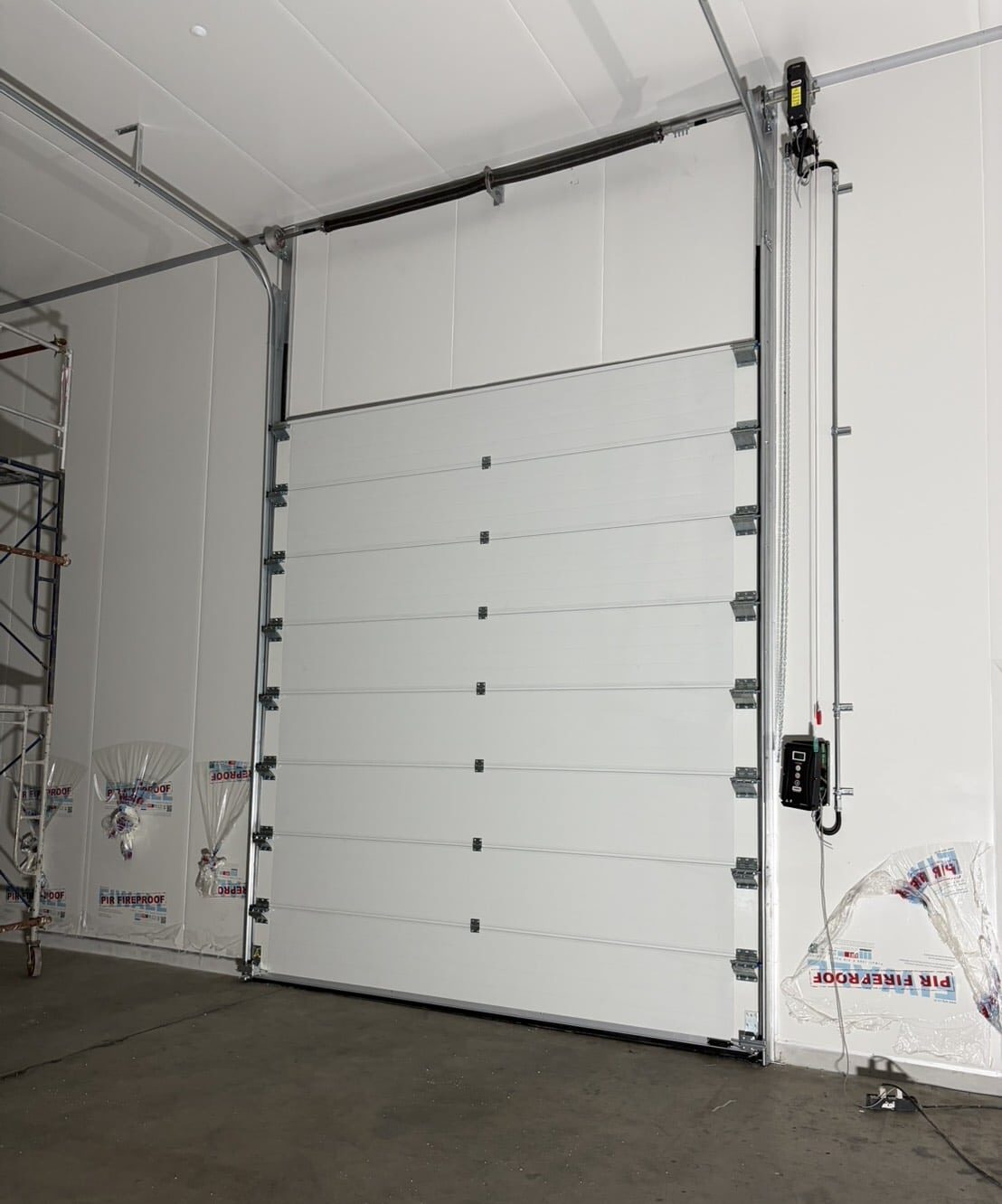 Installation photo of Overhead Factory Door for Manufacturing in Samut Prakan by OZ DOOR
