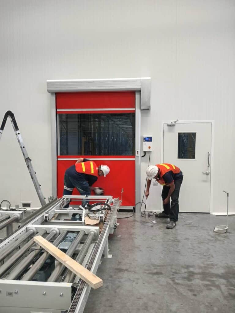 Workers near the bottom edge of the red curtain
