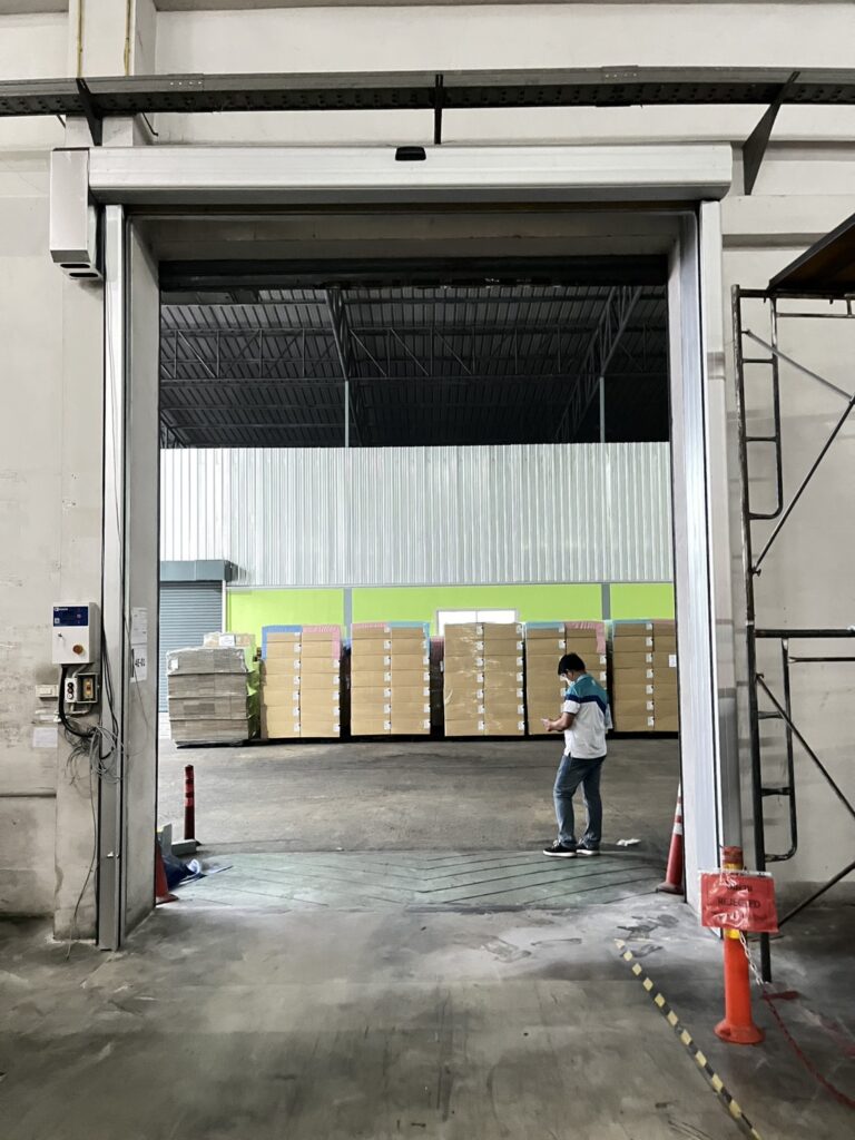 Open doorway leading to stored goods and pallets