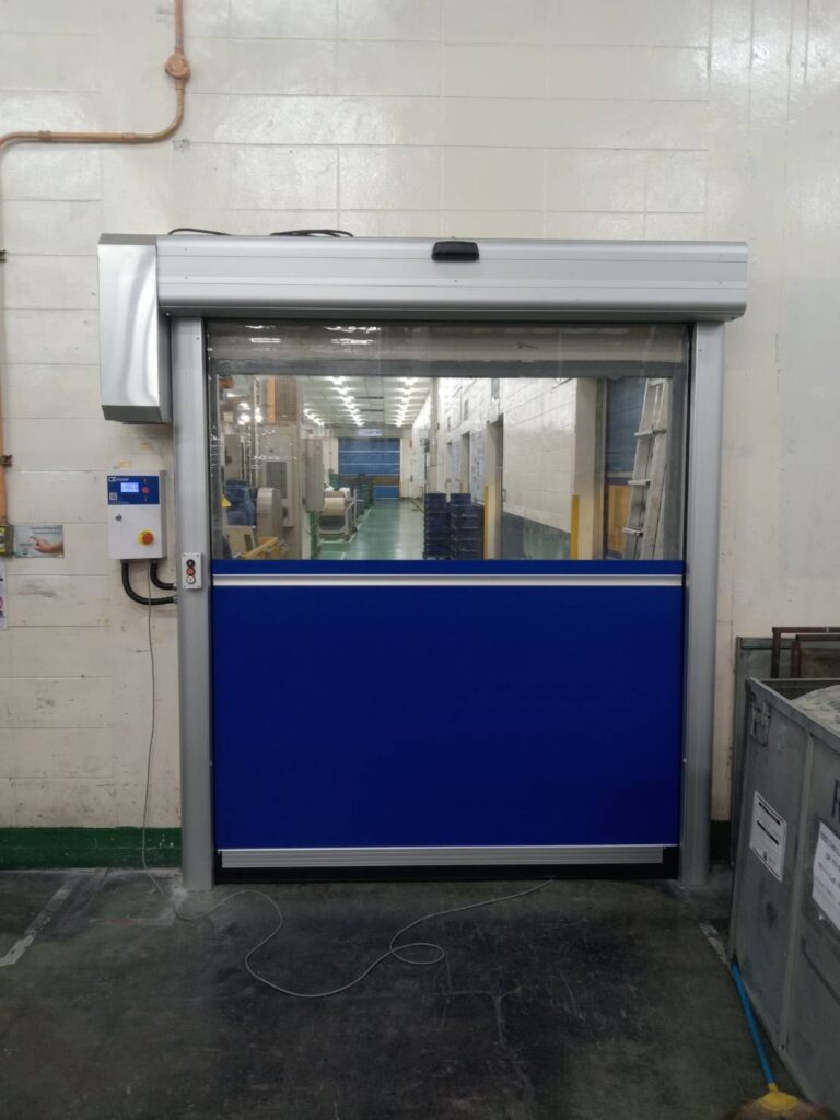 Another view of a small high-speed door with blue lower curtain and clear upper section